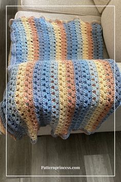 a crocheted blanket sitting on top of a couch