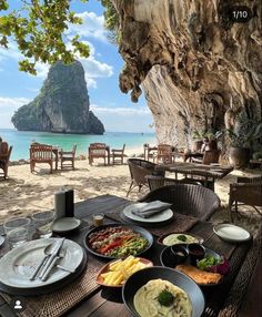 an outdoor dining area overlooking the beach and ocean