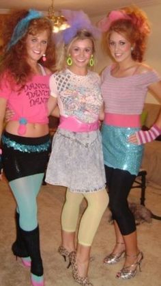 three young women dressed in costumes posing for the camera