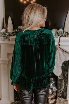 - Be your own kind of beautiful in this luxe feeling top! - Unlined velvet material - A ruffled v-cut neckline with a tie closure - Long, sleeves with a ribbed texture and elastic ruffle cuffs - A relaxed silhouette that ends in a ruffled hemline Green Ruffled Winter Tops, Winter Green Ruffled Tops, Green Ruffled Tops For Winter, Velvet Top, Ribbed Texture, Velvet Material, Velvet Tops, V Cut