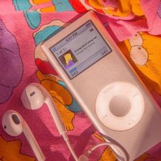 an ipod and headphones are laying on a blanket