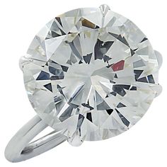 an oval cut diamond ring on a white background