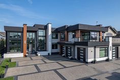 this is an aerial view of a modern house with multiple levels and lots of windows