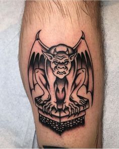 a black and white tattoo with a demon on it