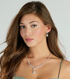 Give off a gorgeously glam shine with this cubic zirconia necklace and earrings set. It features a V-shaped collar necklace with a single row of cubic zirconia stones leading to a two-row curved stone design, accented with a center round stone and a hanging teardrop stone, both outlined with mini cubic zirconia stones for all the more sparkle. The short drop earrings feature a matching round and teardrop cubic zirconia design. Style this luxe set with a cocktail dress and stiletto heels.Fit &amp Dazzling Teardrop Bridal Necklace, Elegant Teardrop Rhinestone Necklace, Cubic Zirconia Teardrop Pendant Bridal Necklace, Elegant Teardrop Pendant Rhinestone Necklace, Zirconia Necklace, Cubic Zirconia Necklace, Necklace And Earrings Set, Stone Design, Accessories Jewelry Necklace