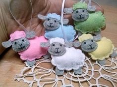 small felt sheep ornament being held by someone's hand