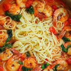 pasta with shrimp, spinach and tomato sauce in a pan