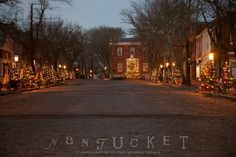 an empty street is decorated with christmas lights