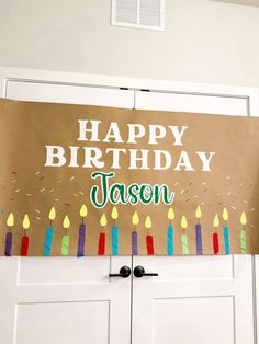 a happy birthday sign with candles on it