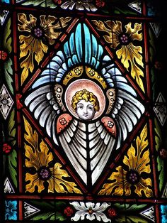 a stained glass window with an angel on it