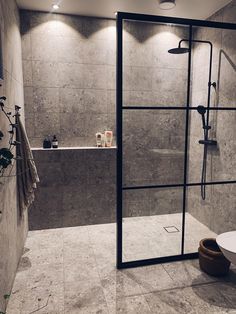 a bathroom with a walk in shower next to a bathtub and toilet bowl on the floor