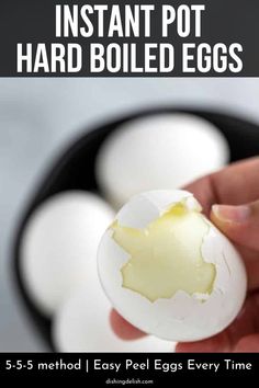 someone holding an egg in their hand with the words instant pot hard boiled eggs