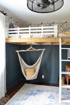 a bedroom with a hammock hanging from the ceiling and a rug on the floor