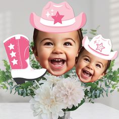 two babies wearing cowboy hats and pink boots with white flowers in front of them on a table