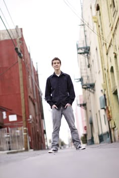 a man standing in the middle of an alleyway with his hands on his hips