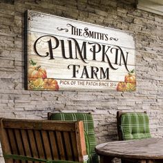 two wooden benches sitting in front of a brick wall with the words pumpkin farm on it