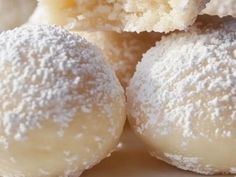 powdered sugar covered doughnuts are stacked on top of each other, ready to be eaten