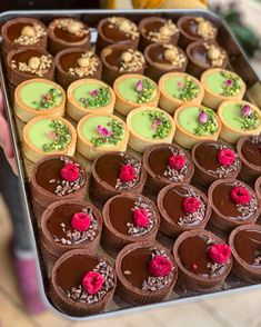 there are many desserts on the tray ready to be eaten