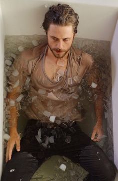 a man sitting in a bathtub filled with water