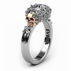 a silver ring with a skull on the side and an embellishment in the middle