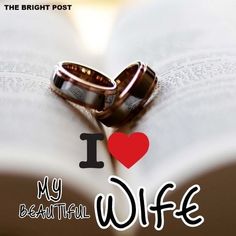 two wedding rings on top of an open book with the words i love my beautiful wife