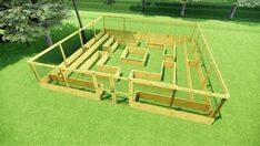 an aerial view of a wooden maze in the grass