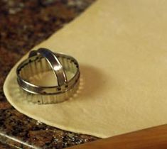 a ring sitting on top of a piece of paper next to a wooden spatula