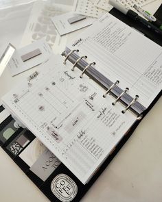 an open planner sitting on top of a desk