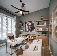 a living room filled with furniture and a ceiling fan