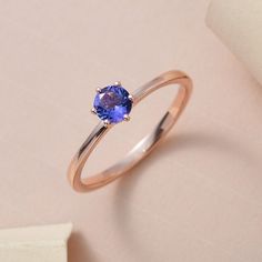 Enrich your jewellery collection with this exquisite solitaire theme inspired AAA tanzanite ring. This ring is crafted from 14K Rose Gold with a fine polish to give it luster and shine. It is studded with an cushion gemstone prong set in the center exhibiting bright blue color sparkle and shine. You can wear this gorgeous ring on your big day to make it even more special.  Item Details- Metal- 14K Solid Rose Gold ( Choose in Option) Stone- AAAA Tanzanite Shape- Round 6x6mm Total Weight- 1.01ctw. Approx. Finish-Silver ( Choose in Option) Setting- Fancy Prong Tanzanite Jewelry, Tanzanite Ring, Tanzanite Gemstone, Emerald Earrings, Solitaire Ring, Prong Setting, Ring Verlobung, Jewelry Collection, Ring Size