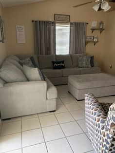 a living room filled with furniture and a ceiling fan