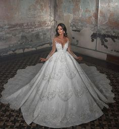 a woman in a white wedding dress posing for the camera