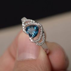 This is a gorgeous handmade creation. Its beauty is its simplicity & Elegance. The 6*6 mm heart cut faceted real London blue topaz is crafted in solid sterling silver and with rhodium plated. All item is sent in a beautiful gift box If you have any idea of design your ring,pls contact me directly. You can realize more lovely stuff clicking the link https://www.etsy.com/shop/knightjewelry?refshopsection_shophome_leftnav Please leave the correct address and you phone number for delivering succ Blue Topaz Rings, Heart Cut Ring, Topaz Rings, Gem Rings, Rings Heart, Cut Rings, Gemstone Solitaire Ring, Heart Wedding Rings, Rings Blue