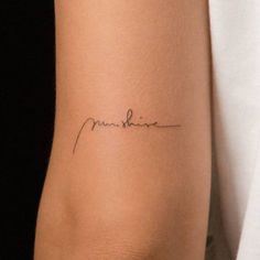 a woman's arm with a small tattoo on it that reads, love shine