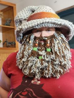 a man wearing a crocheted hat and beard