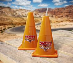 two orange cones with the words cars land on them and pictures of people posing in front