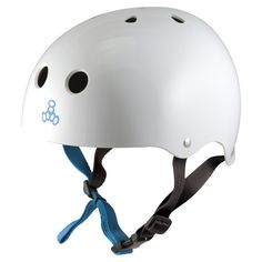 a white helmet with black dots on the side and a blue ribbon around the bottom