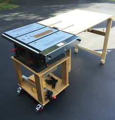 a workbench made out of plywood and other woodworking tools sitting on the ground