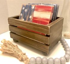 a wooden box with some beads and an american flag on it