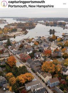 an aerial view of a city with lots of houses and trees in the foreground