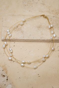 Simple, effortless, dainty freshwater pearl choker designed to go with a wedding gown or with jeans and a tee for date night. Chic Gold Pearl Necklace For Wedding, Gold Single Strand Chic Pearl Necklace, Chic Gold Single Strand Pearl Necklace, Chic Adjustable Gold Pearl Necklace, Classic Gold Pearl Choker, Chic Gold Pearl Choker, Chic Gold Pearl Chain Choker, Choker Designs, Pearl Choker