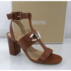 Style Name Michael Kors Izzy T-Strap 40s2izfa2l Shoe Style Dress Block Heel Sandals Material Leather Upper - Heel Height Approx, 3.75 Inch Stacked Block Heel The Izzy Sandal From Michael Michael Kors Is A Sleek Highlight To A Warm Weather Look. With A Leather Construction And Goldtone Detailing, This Strapping Air Catches The Eye. - Adjustable Buckle Strap Closure - Round Open Toe - Synthetic Lining - Lightly Padded Footbed Out-Sole Synthetic Outsole Chic Brown T-strap Sandals With Removable Insole, Luxury Michael Kors Sandals For Spring, Elegant Brown T-strap Sandals With Buckle Closure, Elegant Michael Kors Sandals With Buckle Closure, Chic Brown T-strap Sandals, Michael Kors Sandals With Buckle Closure For Spring, Michael Kors Luxury Leather Sandals, Luxury Leather Michael Kors Sandals, Luxury Michael Kors Leather Sandals