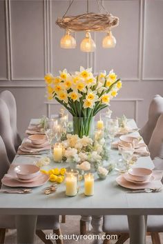 a dining room table set with flowers, candles and place settings for an elegant dinner