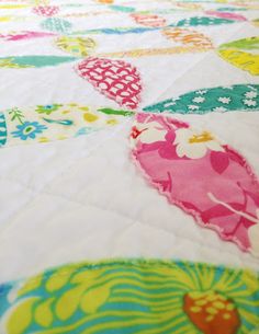 a close up of a quilt with hearts on it