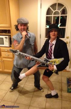 two people are dressed up as rock band members