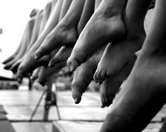 black and white photograph of people's bare feet