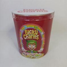 a plastic cup with lucky charms cereal on it's lid sitting on a white surface