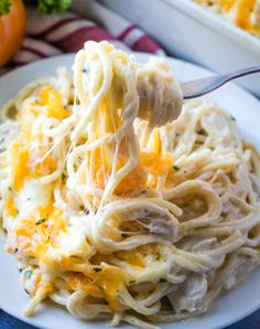 a fork full of pasta and cheese on a plate