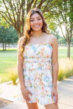 Multi-color ruffled strapless mini dress. It displays a strapless neckline, gathering detailing, and a cinched waist. It also has a ruffled tiered layered mini bottom and a back invisble zipper. Bride Party Dress, Strapless Neckline, Vacation Dresses, Strapless Mini Dress, Orange Dress, Floral Dress Black, Cinched Waist, Dress Romper, Purple Dress