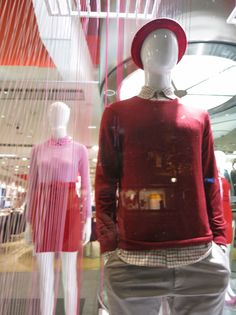 the mannequin is wearing a red sweater and hat